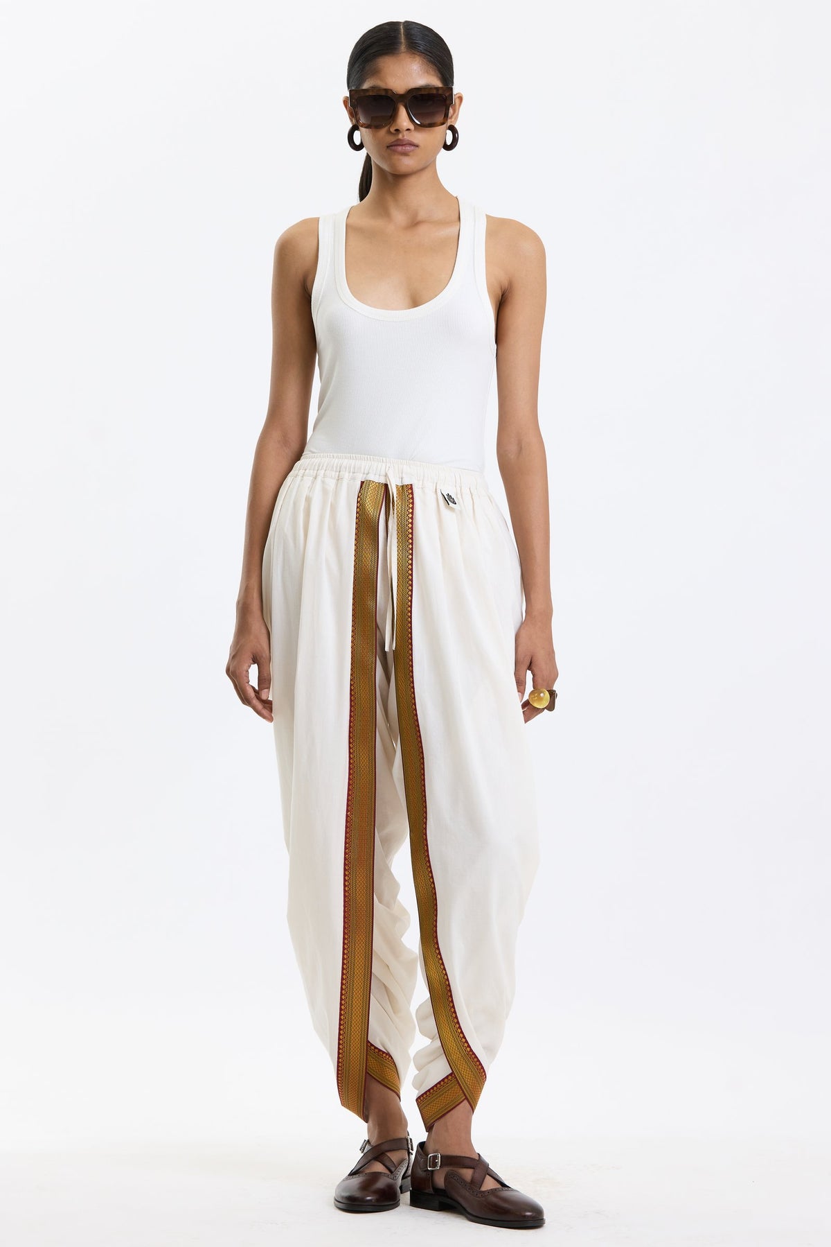 Cotton Dhoti Pants with Zari Border – White & Gold by Swasthii, worn by a model – view 1