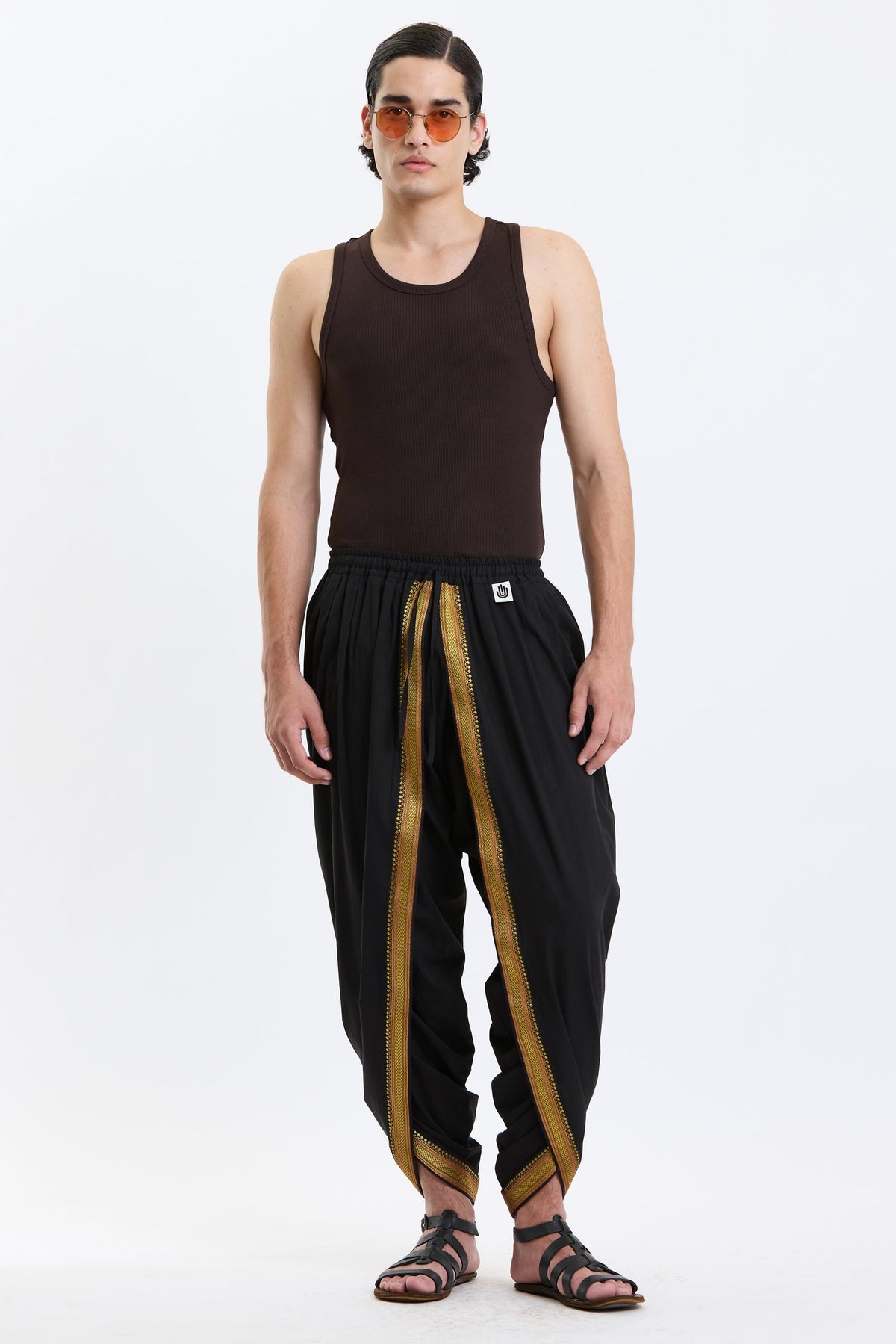 Cotton Dhoti Pants with Zari Border – Black & Gold by Swasthii, worn by a model – view 1