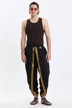 Cotton Dhoti Pants with Zari Border – Black & Gold by Swasthii, worn by a model – view 1